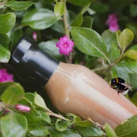 Plastic-Free Shrink Sleeve on a bottle in nature