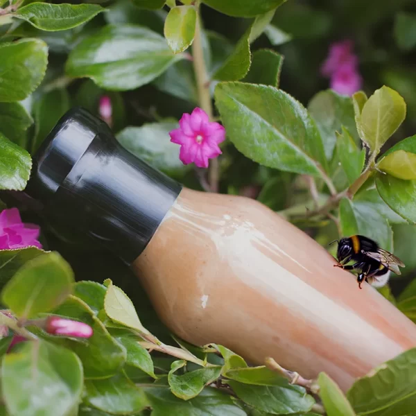 Plastic-Free Shrink Sleeve on a bottle in nature