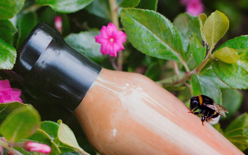 A bumble bee on a sauce bottle in a hedge